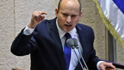 Head of Israel's right-wing Yamina party Naftali Bennett addresses lawmakers during a special session to vote on a new government at the Knesset in Jerusalem, on June 13, 2021. - Israel's Prime Minister Benjamin Netanyahu faced the likely end of his 12-year rule as a fragile alliance of his political enemies hoped to oust him in a parliament vote and form a new government. (Photo by Emmanuel DUNAND / AFP)