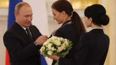 El presidente ruso, Vladímir Putin, impone una insignia a la campeona olímpica de esgrima Sofia Velikaya durante una ceremonia con los medallistas rusos de los Juegos Olímpicos de Río 2016, en el Krémlin, Moscú. EFE