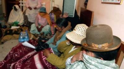 Bolivian prostitutes turn into their second day of hunger strike at an AIDS clinic they took over defending their right to work, in El Alto, 12 km from La Paz, on October 23rd, 2007. Some 50 prostitutes went on a hunger strike Monday and threatened to march naked down the streets of El Alto to reopen the bars and strip joints closed down by the local population last week. Many of El Alto's residents last week demonstrated outside the town's 32 bars and strip joints forcing them to close, complaining that they are magnets for lawbreakers and a bad influence on children. AFP PHOTO/AIZAR RALDES