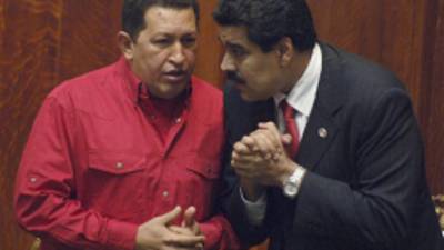 FILE - In this Dec. 18, 2007 file photo Venezuela's President Hugo Chavez, left, talks to then Foreign Minister Nicolas Maduro at the University of Uruguay in Montevideo, Uruguay. Chavez hasn't been seen or heard from since his Dec. 11 cancer surgery, and speculation has grown that his illness could be reaching its final stages. Maduro, who is now vice president and Chavez's chosen successor, is reported to have delayed plans to return home Wednesday, Jan. 2, 2013, after at least two bedside visits with Chavez. The government has provided few details but describes the ailing president's condition, after complications due to a respiratory infection, as 'delicate.' (AP Photo/Matilde Campodonico, File)