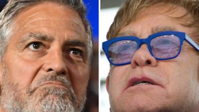 El actor George Clooney y el cantante Elton John. AFP