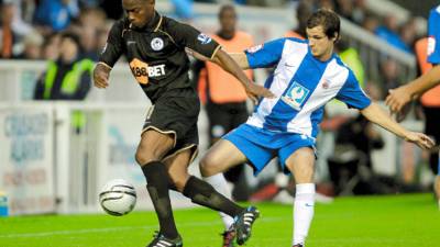 HARTLEPOOL, ENGLAND - AUGUST 24: Maynor Figueroa of Wigan Athletic is challenged by James Brown of Hartlepool United during the Carling Cup second round match between Hartlepool United and Wigan Athletic at Victoria Park on August 24, 2010 in Hartlepool, England. (Photo by Clive Brunskill/Getty Images)