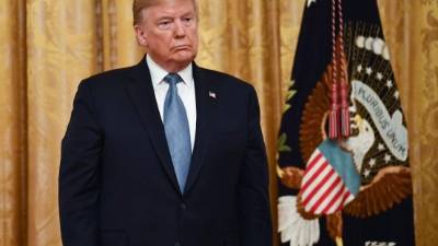 US President Donald Trump looks on before presenting the Presidential Medal of Freedom to retired General Jack Keane, former vice chief of staff of the Army, during a ceremony in the East Room of the White House in Washington, DC on March 10, 2020. (Photo by Brendan Smialowski / AFP)