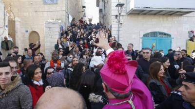 Apostolic Administrator of the Latin Patriarchate of Jerusalem Pierbattista Pizzaballa (C) is greeted by a crowd upon his arrival to the biblical West Bank city of Bethlehem on December 24, 2019. - Pizzaballa will lead the annual Christmas eve procession at the Church of the Nativity. (Photo by HAZEM BADER / AFP)