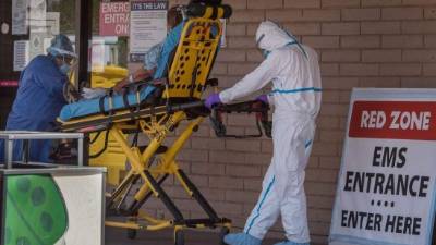 TOPSHOT - A patient is taken from an ambulance to the emergency room of a hospital in the Navajo Nation town of Tuba City during the 57 hour curfew, imposed to try to stop the spread of the Covid-19 virus through the Navajo Nation, in Arizona on May 24, 2020 - Weeks of delays in delivering vital coronavirus aid to Native American tribes exacerbated the outbreak, the president of the hard-hit Navajo Nation said, lashing the administration of President Donald Trump for botching its response. Jonathan Nez told AFP in an interview that of the $8 billion promised to US tribes in a $2.2 trillion stimulus package passed in late March, the first tranche was released just over a week ago. (Photo by Mark RALSTON / AFP)