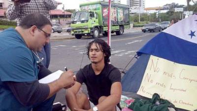 Un joven en huelga de hambre es entrevistado por un reportero.