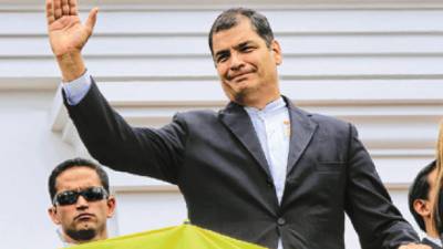 Ecuador's President Rafael Correa, waves to supporters as he attend a military ceremony at the government palace in Quito, Ecuador, Monday, Oct. 4, 2010. Ecuador is under a state of siege, with the military in charge of public order, after soldiers rescued Correa on Thursday from a hospital where he'd been surrounded by police who roughed him up and tear-gassed him earlier. (AP Photo/Martin Mejia)