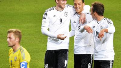 Andre Schürrle celebra con sus compañeros Mario Götze y Mesut Özil.