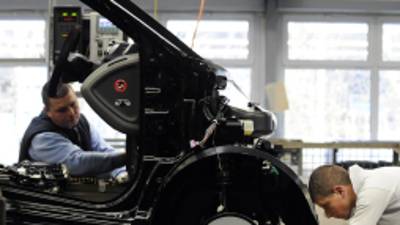 Employees work on the assembly line of the Smart ForTwo car at the Smart factory of Hambach, eastern France, on December 11, 2012. The third-generation Smart electric drive is scheduled to be launched in the U.S. and Europe by the second quarter of 2013 and Smart plans to mass produce the electric car with availability in 30 markets worldwide. AFP PHOTO / JEAN-CHRISTOPHE VERHAEGEN