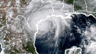 This National Oceanic and Atmospheric Administration satellite image taken on August 25, 2017, shows Hurricane Harvey (L) approaching the coast of Texas.Harvey has intensified into a powerful category three storm, US meteorologists said August 25, as the Gulf Coast states of Texas and Louisiana braced for the first major hurricane to hit land since 2005. Harvey, which is set to make landfall late Friday into early Saturday, was packing maximum sustained winds of close to 120 miles (195 kilometers) per hour, the National Hurricane Center said. / AFP PHOTO / NASA/NOAA / HO / RESTRICTED TO EDITORIAL USE - MANDATORY CREDIT 'AFP PHOTO / NOAA/CIRA/RAMMB' - NO MARKETING NO ADVERTISING CAMPAIGNS - DISTRIBUTED AS A SERVICE TO CLIENTS