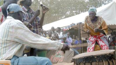 A local Villagers celebrate in the village of Kogelo, western Kenya, Sunday, Jan. 18, 2009. Villagers and tourists celebrate in Kogelo, Kenya, the village where U.S. president-elect Obama's step-grandmother still lives, ahead of Obama's inauguration in U.S.A. which will take place on upcoming Tuesday. (AP Photo/ Dan Keyi)