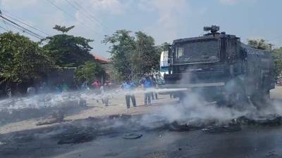 La tanqueta de la Policía Nacional se encargó de quitar los residuos de las llantas quemadas en la carretera internacional CA-4.