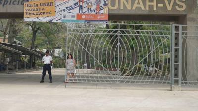 Una estudiante camina frente al portón de acceso de la Universidad Nacional Autónoma de Honduras campus Cortés (Unah-Cortés).
