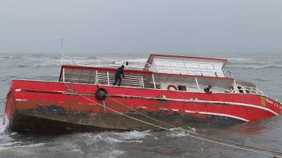 El bote carguero Dreams Of The Seas se dio vuelta en la dársena del muelle de cabotaje. El incidente se debió a desperfectos en el motor debido a la presión por el fuerte oleaje producto de las lluvias en el litoral. <b>Foto: LA PRENSA</b>