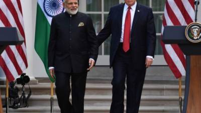 US President Donald Trump (R) guides Indian Prime Minister Narendra Modi towards a joint press conference in the Rose Garden at The White House in Washington D.C on June 26, 2017. US President Donald Trump is hosting Indian Prime Minister Narendra Modi for a first face-to-face meeting, seeking to forge a chemistry that can add new fizz to a flourishing relationship between the world's two largest democracies. / AFP PHOTO / Nicholas Kamm