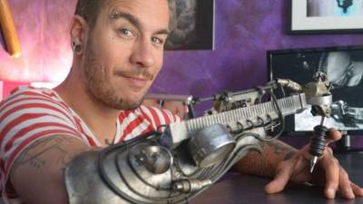 Jc Sheitan Tenet, de nacionalidad francesa, lleva tatuando más de una década. Siempre tuvo que hacerlo con la mano izquierda, con la que había aprendido a desenvolverse desde los diez años, cuando perdió la otra extremidad, y no fue hasta hace dos que su amigo y escultor Jean-Louis González le propuso crear un aparato con el que pudiese tatuar.