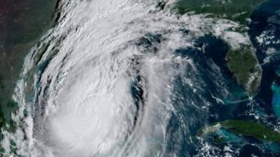 LAKE ARTHUR, LA - OCTOBER 09: A person records rain and wind on his smartphone as Hurricane Delta makes landfall on October 9, 2020 in Lake Arthur, Louisiana. Hurricane Delta makes its way toward Louisiana, threatening to bring powerful winds and storm surge to the area of the coast still recovering from Hurricane Laura. Go Nakamura/Getty Images/AFP