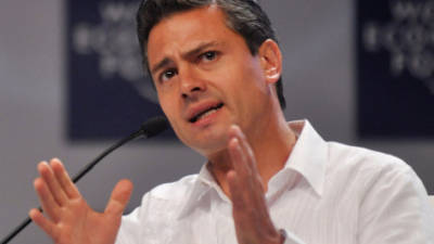 Mexican President Enrique Pena Nieto looks at the French flag during a welcoming ceremony at the Hotel National des Invalides in Paris, on July 13, 2015. Mexican President is paying a state visit to France this week amid the shock of drug lord Joaquin 'El Chapo' Guzman's dramatic escape from a maximum security prison in Mexico. Mexico is the guest of the Bastille Day parade. The Invalides especially houses former French Emperor Napoleon's tomb, an army museum and a church. AFP PHOTO / POOL / THIBAULT CAMUSTHIBAULT CAMUS/AFP/Getty Images ** OUTS - ELSENT, FPG - OUTS * NM, PH, VA if sourced by CT, LA or MoD **