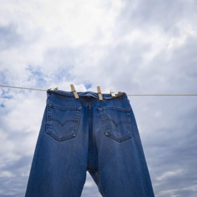 Cloudy sky with pant hung to wire for drying.