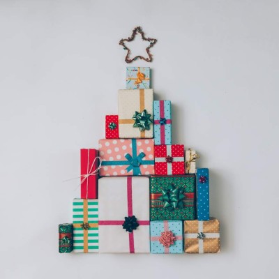 Christmas tree made of colorful presents and gifts. Flat lay. Holiday concept.
