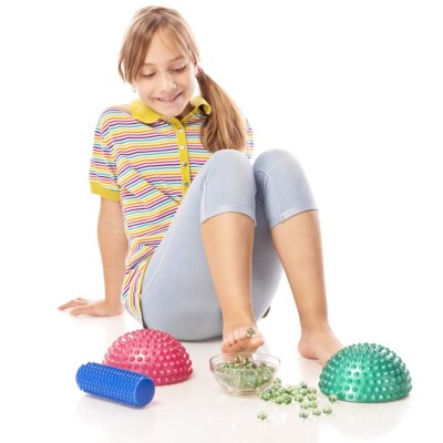 Little girl performing flat feet exercises, isolated on white background