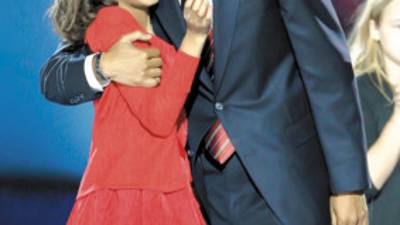 President-elect Barack Obama hugs his daughter, Malia, after his acceptance speech at his election night party at Grant Park in Chicago, Tuesday night, Nov. 4, 2008. (AP Photo/Morry Gash)