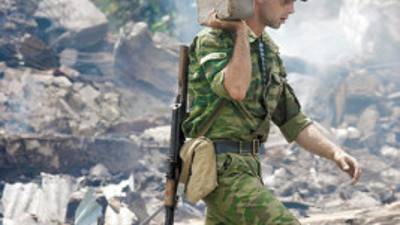 An AbKhazian soldier examines the site of former Georgian military installations 100km east of Sukhumi in the town Adzhara on August 15, 2008 in the remote Kodori gorge of Georgia's breakaway Abkhazia republic. Russian President Dmitry Medvedev has 'not honoured' his promise to halt military operations in Georgia, US Secretary of State Condoleezza Rice said. AFP PHOTO / VIKTOR DRACHEV