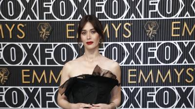 Lizzy Caplan luciendo un elegante vestido negro