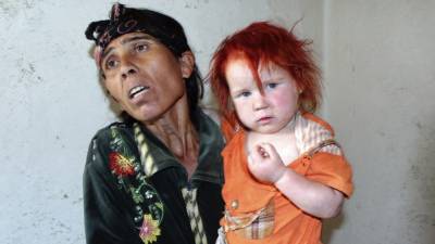 La madre de María es de mediana estatura y contextura delgada.