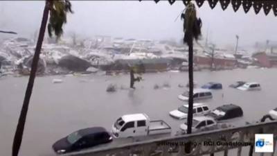 A handout grab image made from a video released on September 6, 2017 by RCI Guadeloupe shows flooded streets and damage on the French overseas island of Saint-Martin, filmed from a terrace of the Beach Plaza hotel after high winds from Hurricane Irma hit the island. Monster Hurricane Irma slammed into Caribbean islands today after making landfall in Barbuda, packing ferocious winds and causing major flooding in low-lying areas. As the rare Category Five storm barreled its way across the Caribbean, it brought gusting winds of up to 185 miles per hour (294 kilometers per hour), weather experts said. / AFP PHOTO / RCI Guadeloupe / Rinsy XIENG / RESTRICTED TO EDITORIAL USE - MANDATORY CREDIT 'AFP PHOTO / RCI Guadeloupe / Rinsy XIENG' - NO MARKETING NO ADVERTISING CAMPAIGNS - DISTRIBUTED AS A SERVICE TO CLIENTS - NO INTERNET - NO RESALE - IMAGE AVAILABLE AS PART OF A 48-HOUR RIGHT TO INFORMATION FROM WEDNESDAY 6TH OF SEPTEMBER 2017 8PM GMT /