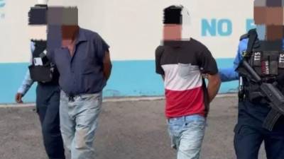 Los dos hombres, tras ser detenidos por agentes policiales.