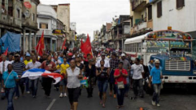 Demonstrators march during a protest in downtown Colon, Panama, Wednesday, Oct. 24, 2012. Panama's President Ricardo Martinelli said Wednesday that he is willing to cancel plans to sell state-owned land in a duty-free zone on the Panama Canal following a week of sometimes violent protests in which a 10-year-old boy and two adults died. (AP Photo/Arnulfo Franco)