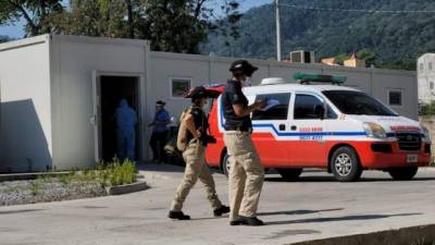 Agentes de la Atic ingresando al predio del hospital móvil de San Pedro Sula. Foto: cortesía.