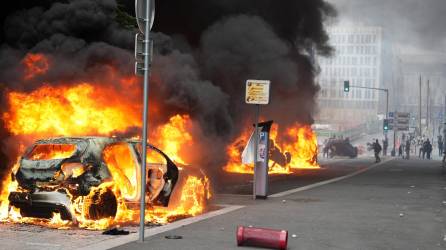 A photopraph taken on June 29, 2023 shows cars burning on the street as clashes erupted at the end of a commemoration march for a teenage driver shot dead by a policeman, in the Parisian suburb of Nanterre. Violent protests broke out in France in the early hours of June 29, 2023, as anger grows over the police killing of a teenager, with security forces arresting 150 people in the chaos that saw balaclava-clad protesters burning cars and setting off fireworks. Nahel M., 17, was shot in the chest at point-blank range in Nanterre in the morning of June 27, 2023, in an incident that has reignited debate in France about police tactics long criticised by rights groups over the treatment of people in low-income suburbs, particularly ethnic minorities. (Photo by Zakaria ABDELKAFI / AFP)