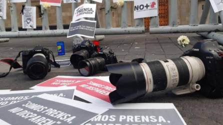 Cámaras fotográficas puestas en el suelo como señal de protesta por la violencia contra los periodistas.