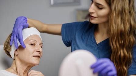Young female doctor talks about beauty treatments during a consultation with a mature woman patient