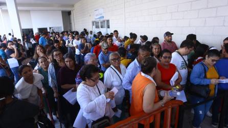 Cientos de hondureños se forman en filas afuera del INM en San Pedro Sula. Fotos: M. Valenzuela