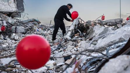 Un fotógrafo turco coloca globos en los escombros de un edificio en Antakya donde murieron tres niños.