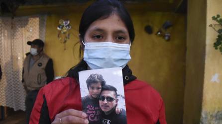 Lucrecia Alba Xaminez, 28, muestra una foto de su esposo Celso Escu Pacheco, uno de los pocos sobrevivientes al fatal accidente del pasado viernes.