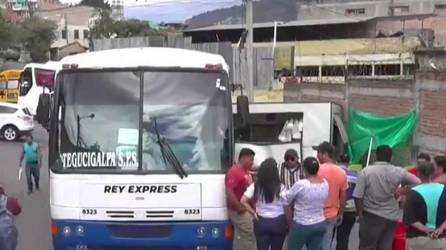 Autobús del transporte público con personas a su alrededor luego del accidente en Comayagüela.