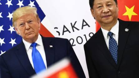 (FILES) In this file photo taken on June 29, 2019 Chinese President Xi Jinping (R) and US President Donald Trump attend their bilateral meeting on the sidelines of the G20 Summit in Osaka, Japan. - Trump on September 3, 2019, warned Beijing not to drag its feet in trade negotiations in hopes of getting a better deal should he lose next year's presidential elections. 'While I am sure they would love to be dealing with a new administration... 16 months PLUS is a long time to be hemorrhaging jobs and companies,' Trump said on Twitter. 'And then, think what happens to China when I win. Deal would get MUCH TOUGHER!' (Photo by Brendan Smialowski / AFP)