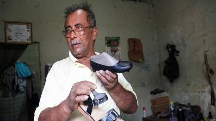 <b>Óscar Gómez muestra el calzado que elabora en la sala de su pequeña vivienda; locales frente a fábrica de Choloma permanecen vacíos. Fotos: José Cantarero y Héctor Edú. </b>
