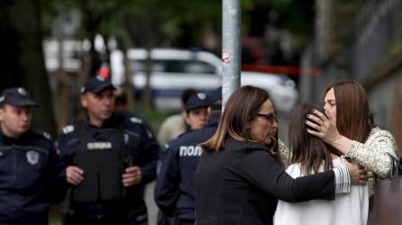 Profesoras consuelan a una estudiante después de que nueve personas murieran y varias resultaran heridas en una escuela de Belgrado, Serbia.