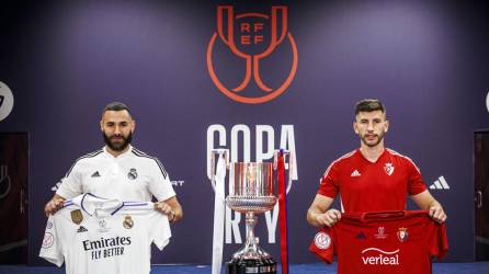 Los capitanes del Real Madrid, Karim Benzemá (i), y de Osasuna, David García, posan con las camisetas ante el trofeo en la jornada previa a la final de la Copa del Rey.