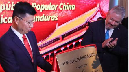 El consejero de la Cancillería de China Yu Bo (i) y el ministro de Relaciones Exteriores de Honduras Enrique Reina develan una placa en la inauguración de la embajada de la República Popular China en Tegucigalpa.