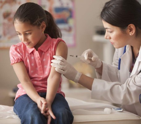 Doctor giving child patient injection