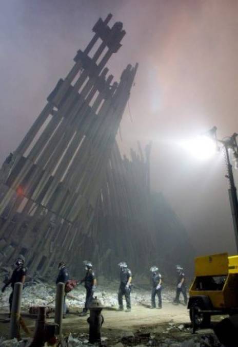 "(FILES) In this file photo taken on September 10, 2001, firefighters make their way through the rubble of the World Trade Center in New York. - The remains of two more victims of 9/11 have been identified, thanks to advanced DNA technology, New York officials announced on September 8, 2021, just days before the 20th anniversary of the attacks. The office of the city's chief medical examiner said it had formally identified the 1,646th and 1,647th victim of the al-Qaeda attacks on New York's Twin Towers which killed 2,753 people. They are the first identifications of victims from the collapse of the World Trade Center since October 2019. (Photo by DOUG KANTER / AFP)"