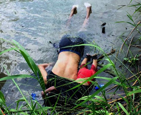 View of the bodies of Salvadoran migrant Oscar Martinez Ramirez and his daughter, who drowned while trying to cross the Rio Grande -on their way to the US- in Matamoros, state of Tamaulipas on June 24, 2019. - Twenty-five-year-old Oscar Martinez Ramirez fled El Salvador with his 21-year-old wife and their daughter and decided to make the risky crossing from Mexico to the US on Sunday afternoon, according to a Mexican court report seen by AFP. Ramirez carried the little girl on his back, stowing her inside his t-shirt to keep her safe as they attempted to cross the river. But the pair were swept away by violent currents, drowning before her mother's eyes, who survived the ordeal and arrived on shore. (Photo by STR / AFP) / The erroneous mention[s] appearing in the metadata of this photo by STR has been modified in AFP systems in the following manner: [state of Tamaulipas] instead of [state of Coahuila]. Please immediately remove the erroneous mention[s] from all your online services and delete it (them) from your servers. If you have been authorized by AFP to distribute it (them) to third parties, please ensure that the same actions are carried out by them. Failure to promptly comply with these instructions will entail liability on your part for any continued or post notification usage. Therefore we thank you very much for all your attention and prompt action. We are sorry for the inconvenience this notification may cause and remain at your disposal for any further information you may require.