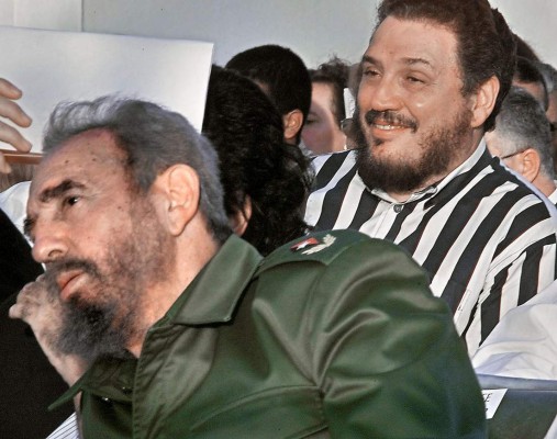 (FILES) File photo dated on February, 2002 of Castro's elder son, nuclear physicist Fidel Castro Diaz-Balart (R), next to his father, Cuban leader Fidel Castro, during the Havana Book Fair opening.Fidel Castro's eldest son committed suicide: Cuba state media on February 1, 2018. / AFP PHOTO / Adalberto ROQUE