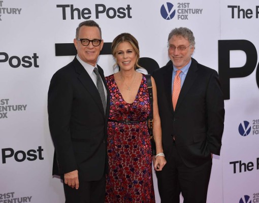 (FILES): This file photo taken on December 14, 2017 shows from left: Tom Hanks, Rita Wilson and Marty Baron arriving for the premiere of 'The Post' in Washington, DC.At a time when the media is being accused of peddling 'fake news,' Steven Spielberg, Meryl Streep and Tom Hanks are bringing Hollywood star power to a movie celebrating journalism and the virtues of a free press. 'The Post,' which comes out in theaters in the United States on Friday, recounts the nail-biting behind-the-scenes story of the 1971 publication by The Washington Post of the Pentagon Papers, which exposed the lies behind US involvement in the Vietnam War. / AFP PHOTO / Mandel NGAN